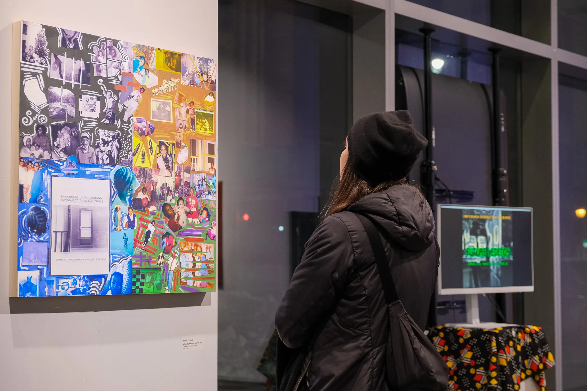 A visitor views a colorful mixed-media collage artwork on display at the Future Legends exhibition